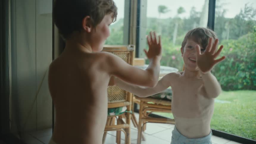 Two children play by the glass door