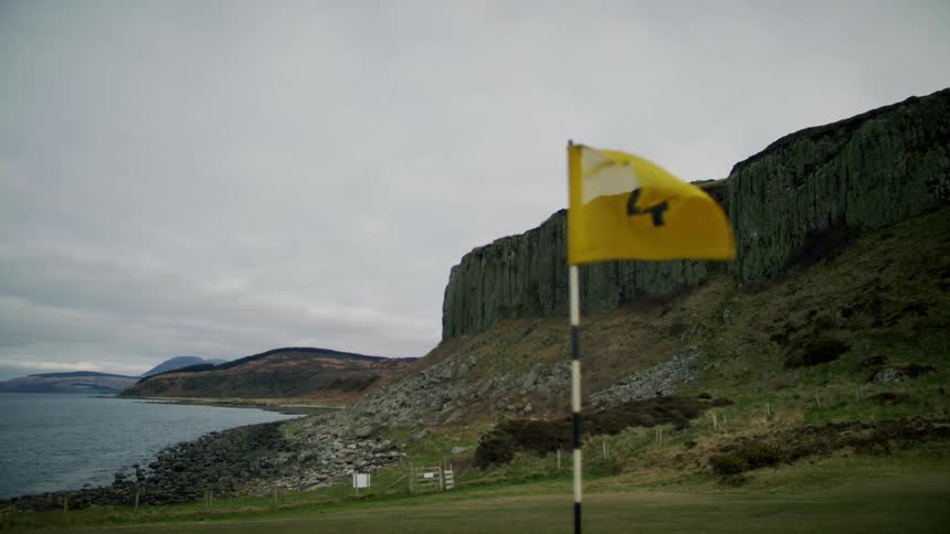 A flag blows in the wind on the golf course