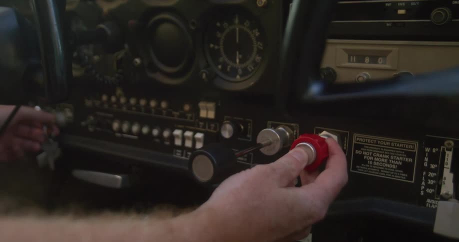 Close up of a hand pulling a knob in an airplane dashboard
