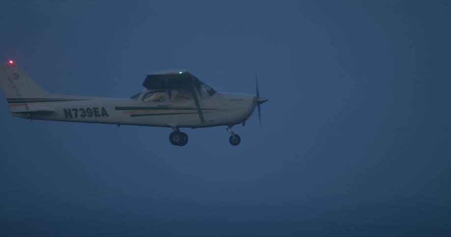 A small engine airplane flying in the bright blue sky
