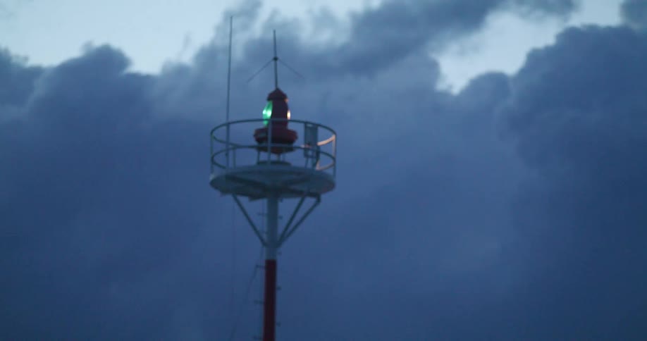 Spinning lights on a light house at evening