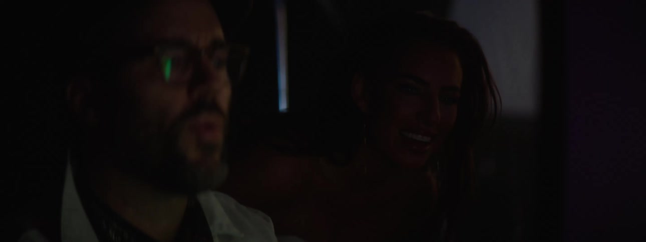 Man and a woman talking while looking at a computer screen indoor