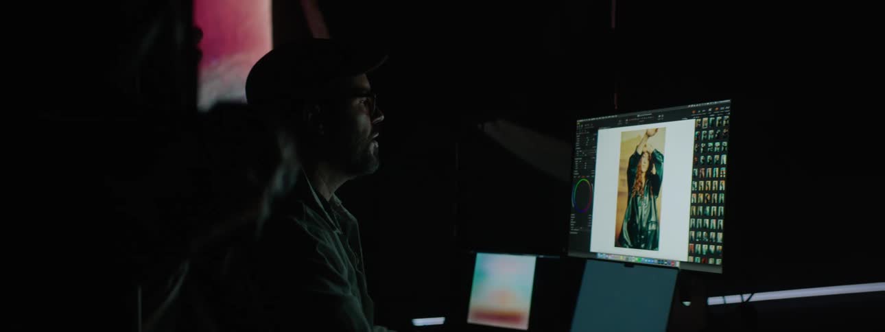 A photographer reviewing images on a computer screen