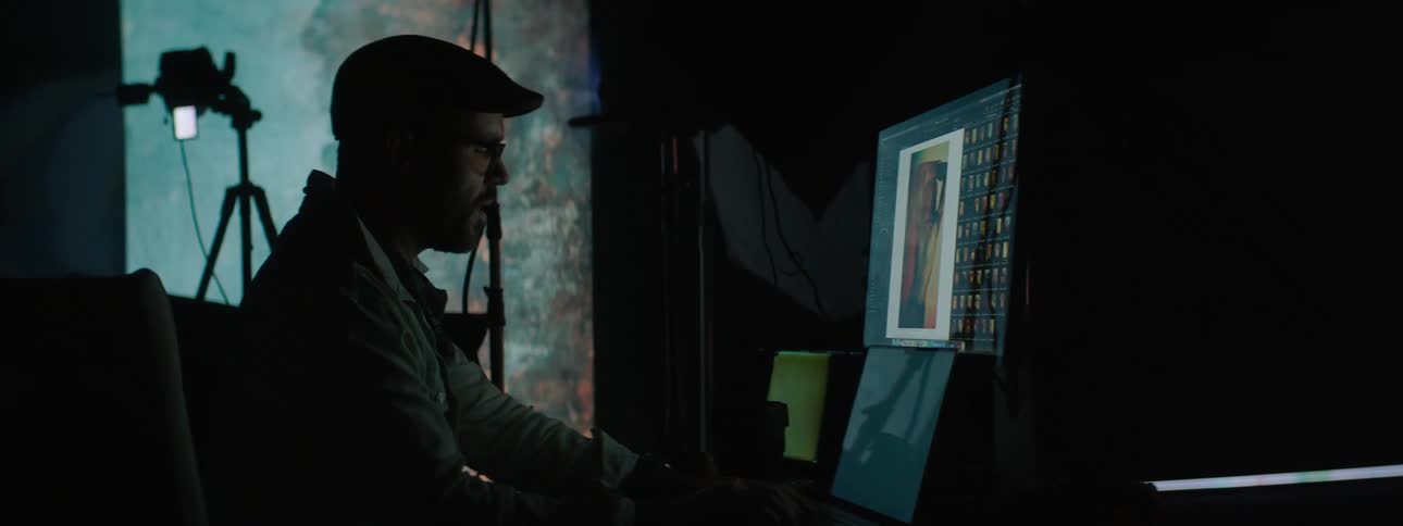 A man is using a computer in the studio