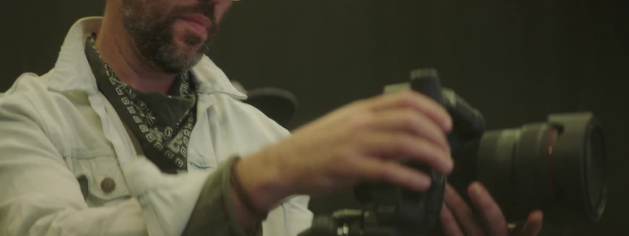 A man adjusts his camera