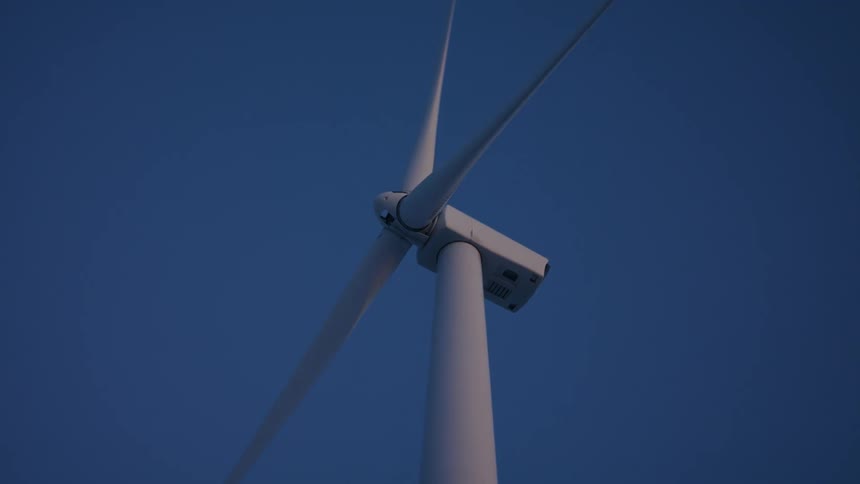 Turbine of a wind farm rotating during the day