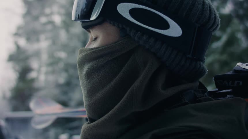 A person has his eyes closed and his face is wearing cold clothes and he is also wearing a cap
