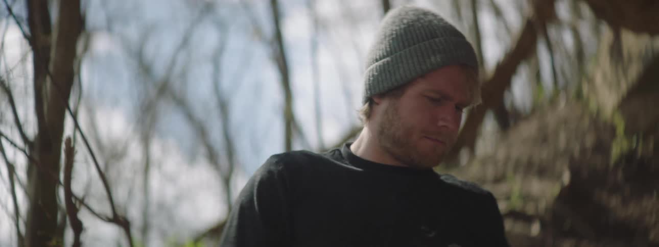 A man goes through his backpack while camping