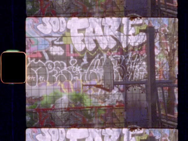 Basketball court with graffiti covered walls in the background