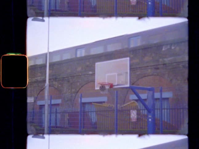 A man shooting a basketball outdoors