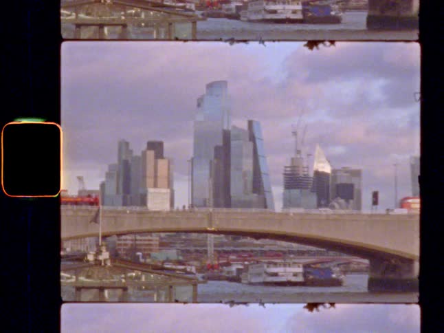 Red bus drives across a bridge in London