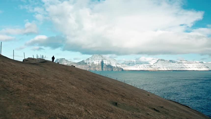 An aerial view of mountains at the edge of the ocean