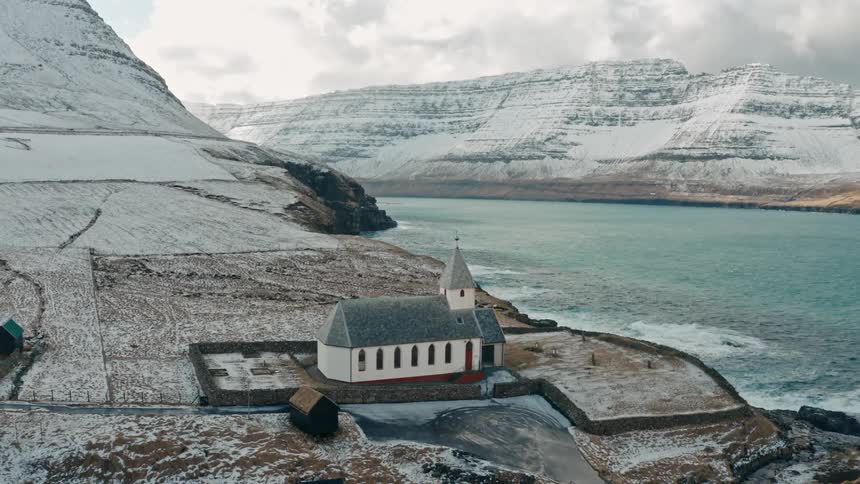 A clip of a building on a mountain at the sea shore