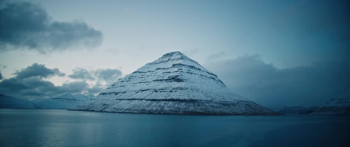A mountain surrounded by water