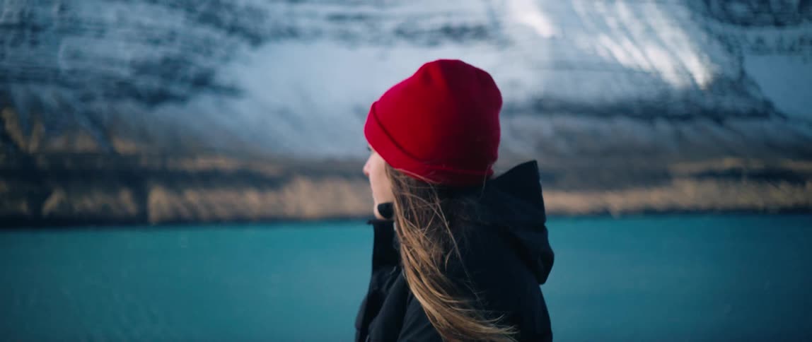 A woman gazes at a snowy mountain