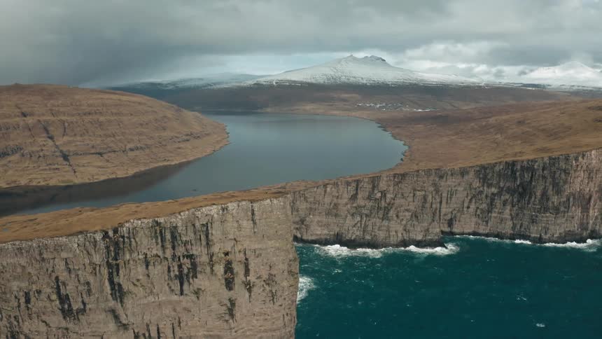 Aerial panorama of the sea within a bay with cliffs in winter