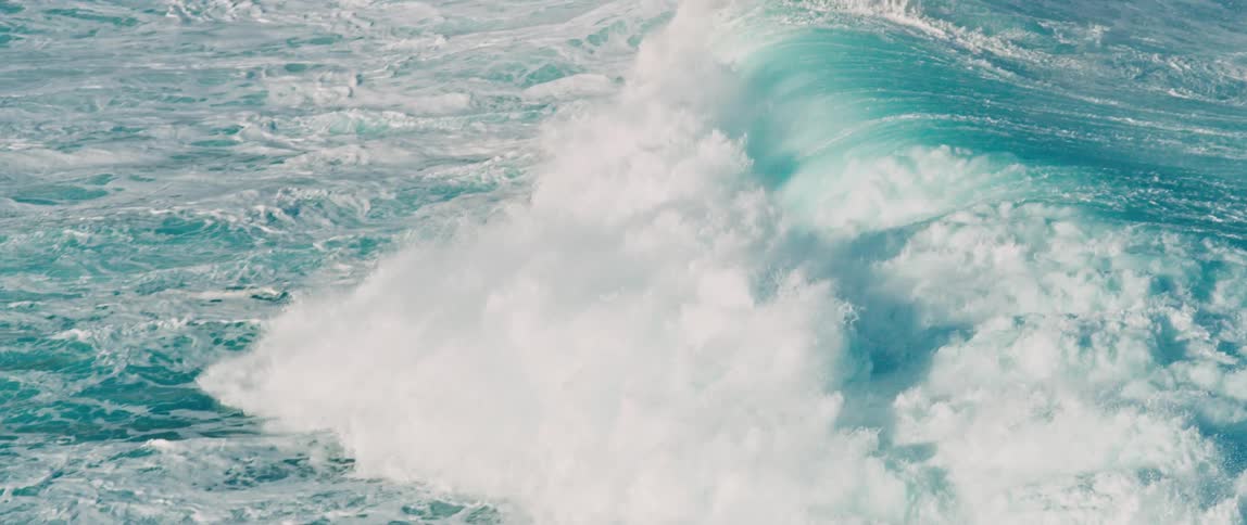 Ocean waves breaking against the beach
