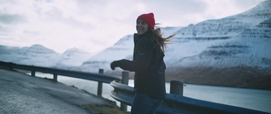 A woman is running past the mountains