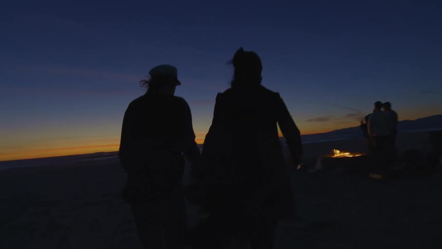 Two people running outdoors at sunset