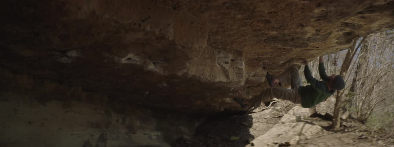 A man climbing a mountain without safety equipment