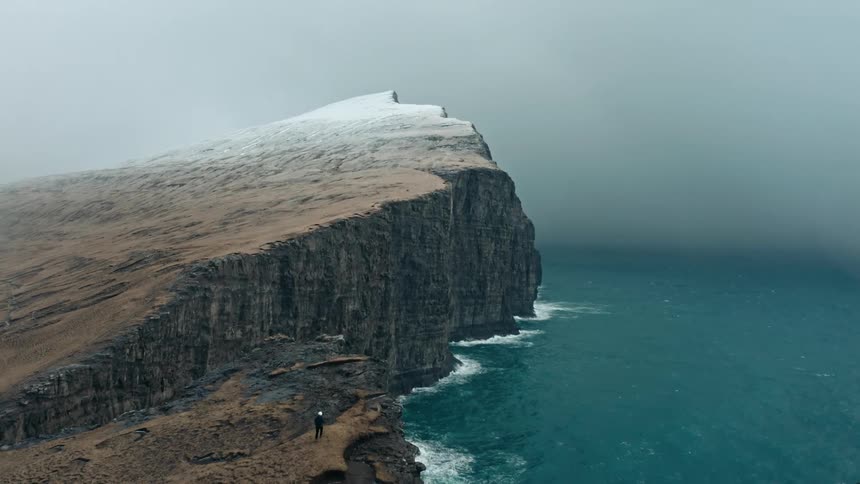 Aerial panorama of a promontory and coastal area by the sea on a cloudy day