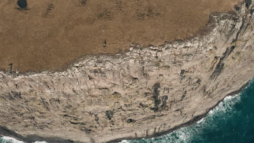 A person is running along the cliff