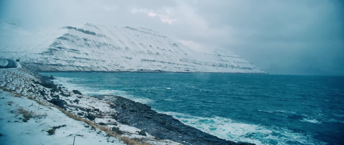 Landscape of snowy coast and a mountain