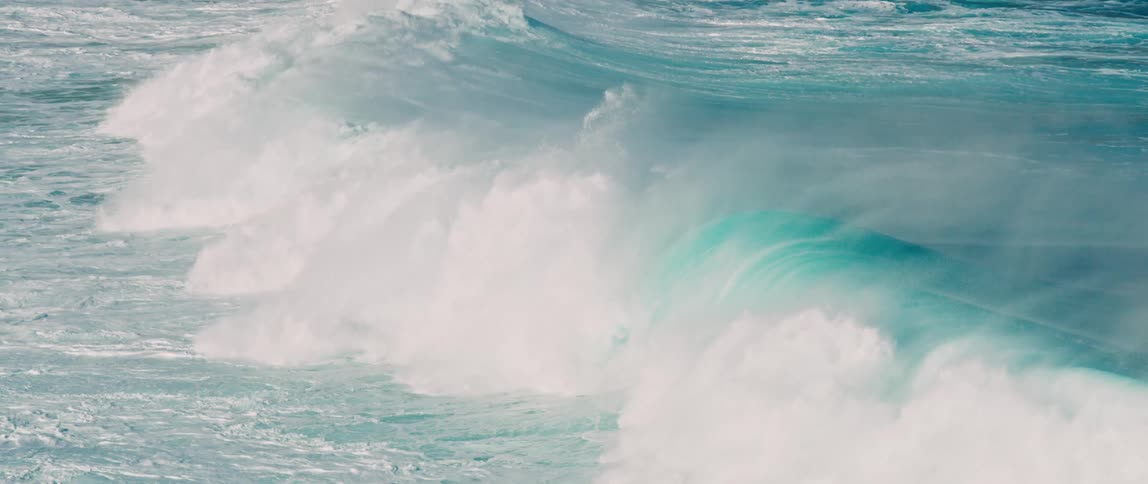 A powerful wave cresting and crashing in the ocean