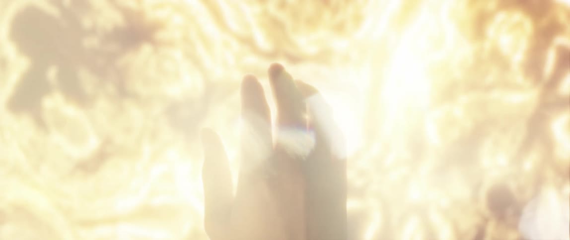 Dreamy scene of the silhouette of a hand in front of sunlight