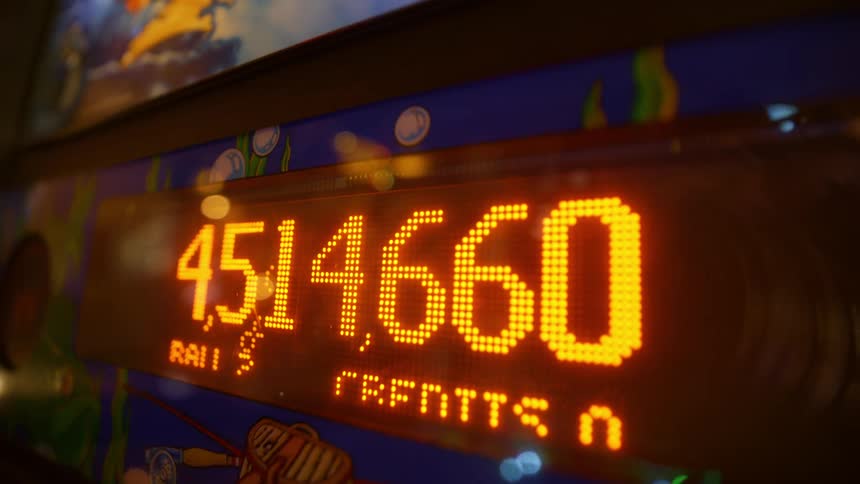 Digital fish swims behind score on pinball machine display