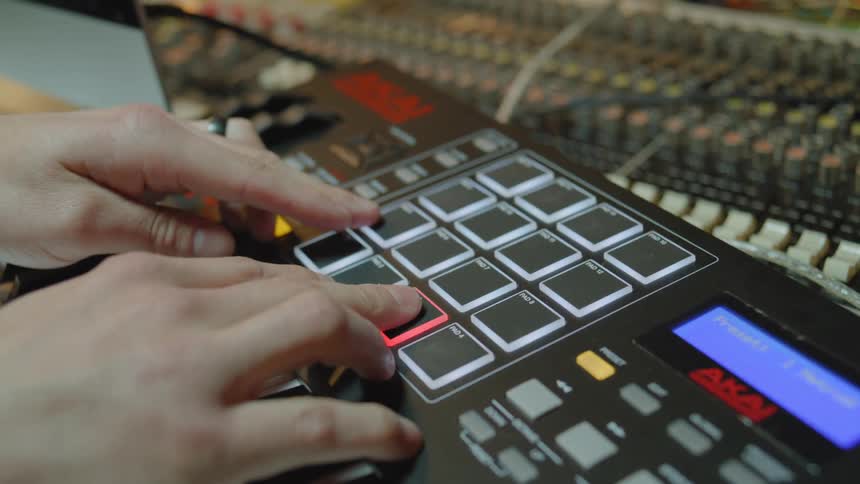 Closeup of a persons hands typing on a dj musical instrument
