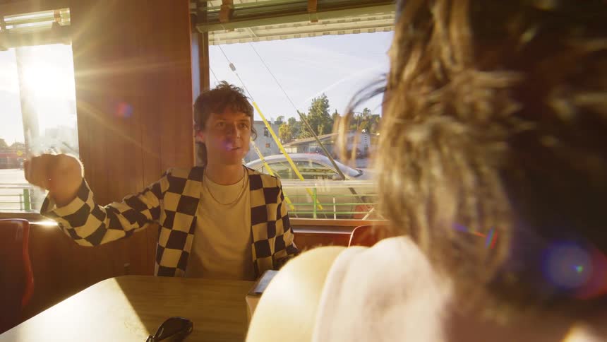 A man talking to someone in a diner