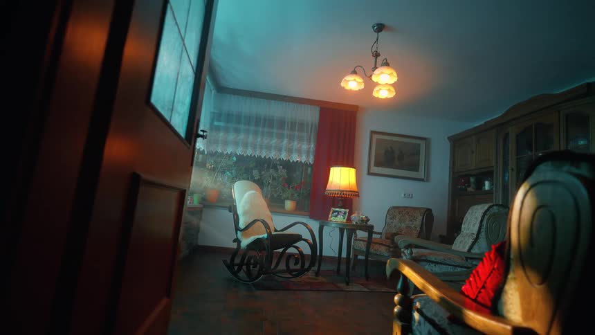 View of a room with armchairs and a table lamp