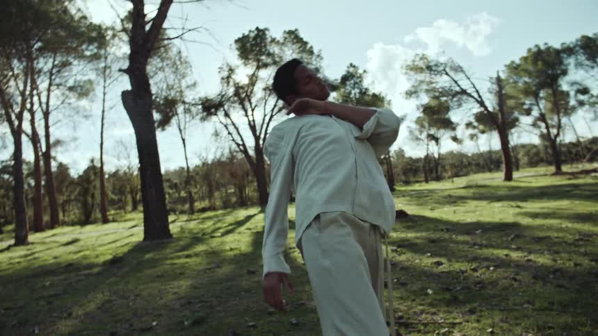 Black boy dancing in a forest