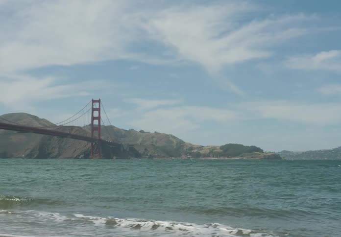 A bridge over the sea at high tide during the day