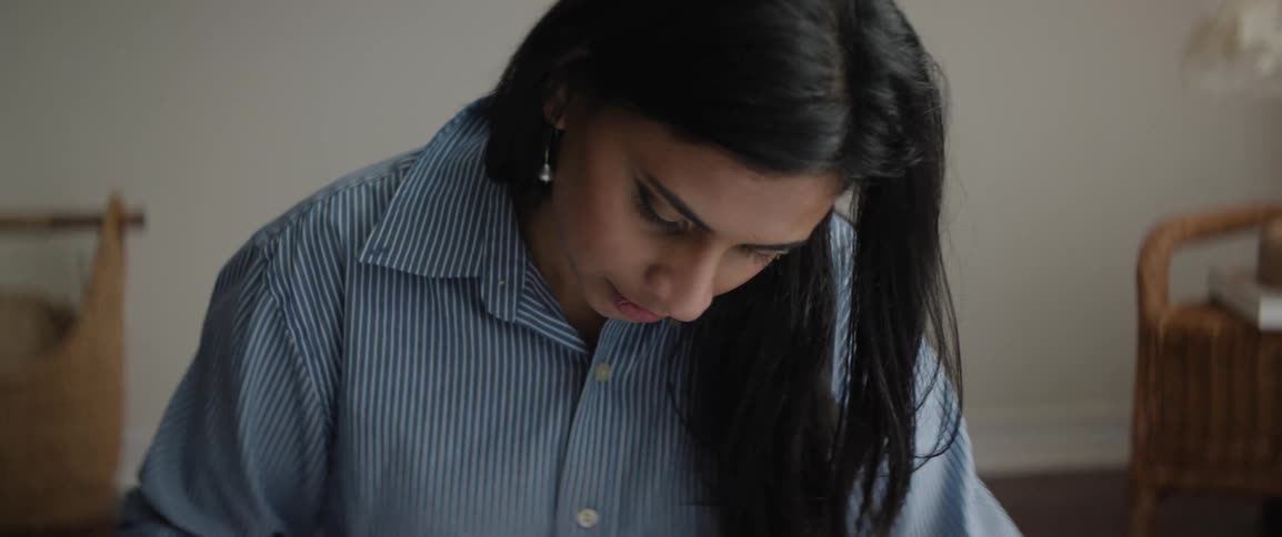A woman is writing in a notebook