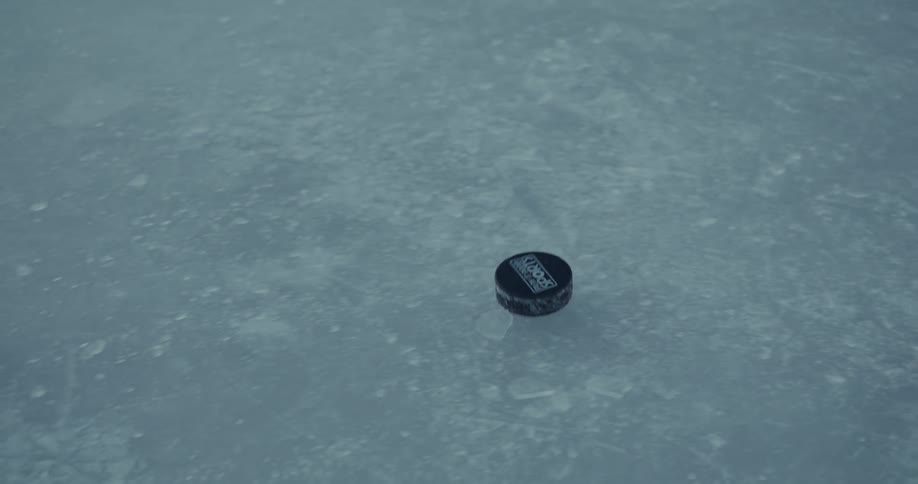 A clip of a ice hockey ball played by a hockey player