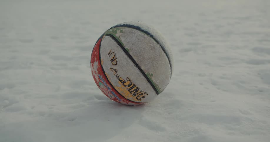 Closeup of a basketball in the middle of the snow