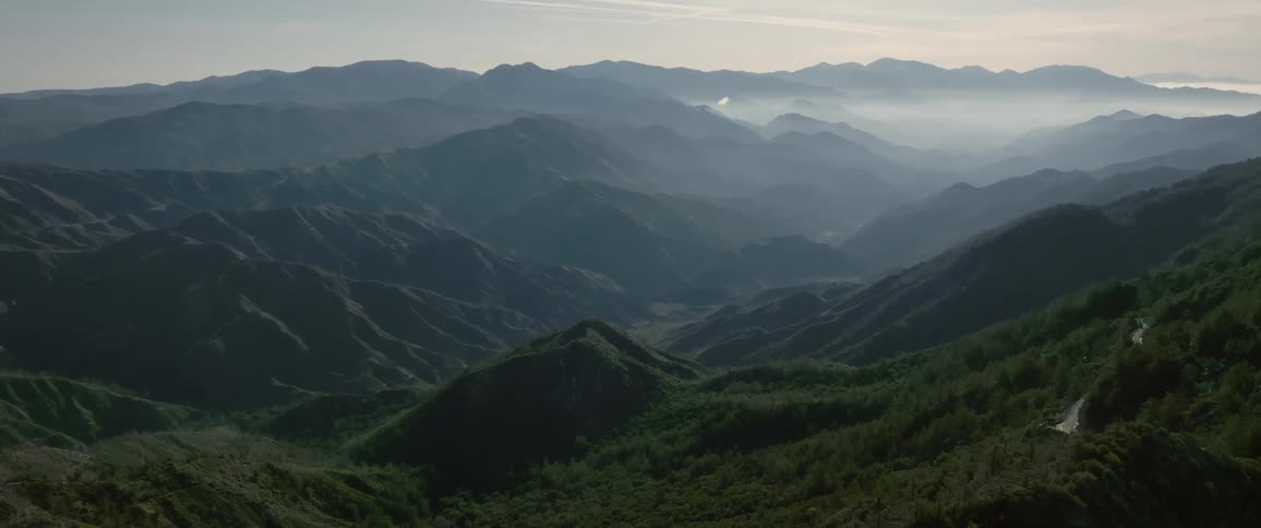 A large mountain range covered by trees