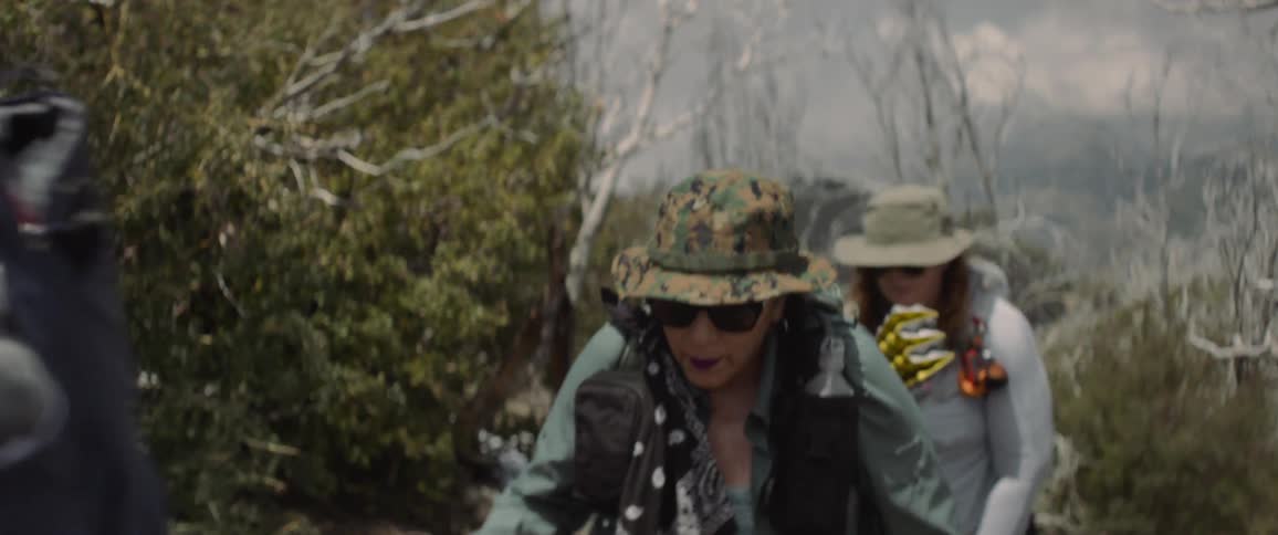 A group of women hiking up a slope in single file