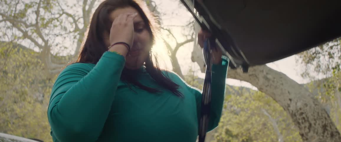 Portrait of a woman opening the car trunk