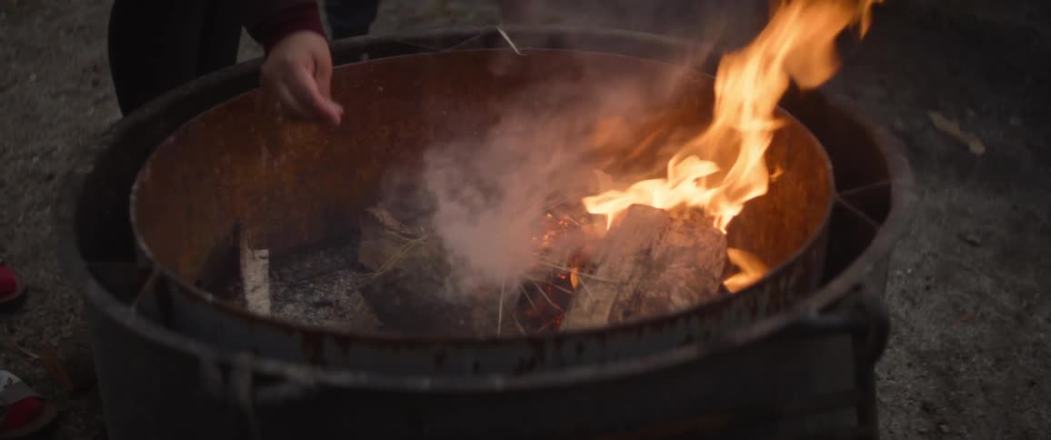 Two people starting a fire