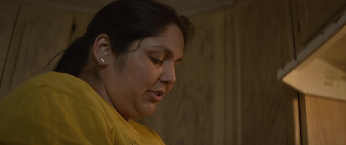 A woman is cooking in the kitchen