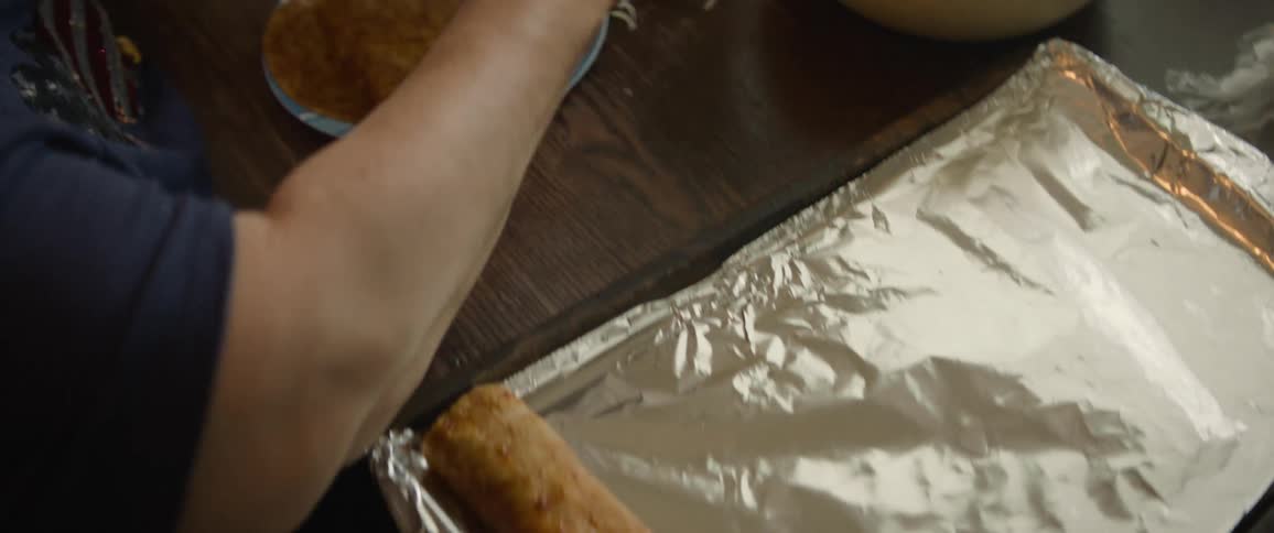 Closeup of a womans hands preparing a burrito