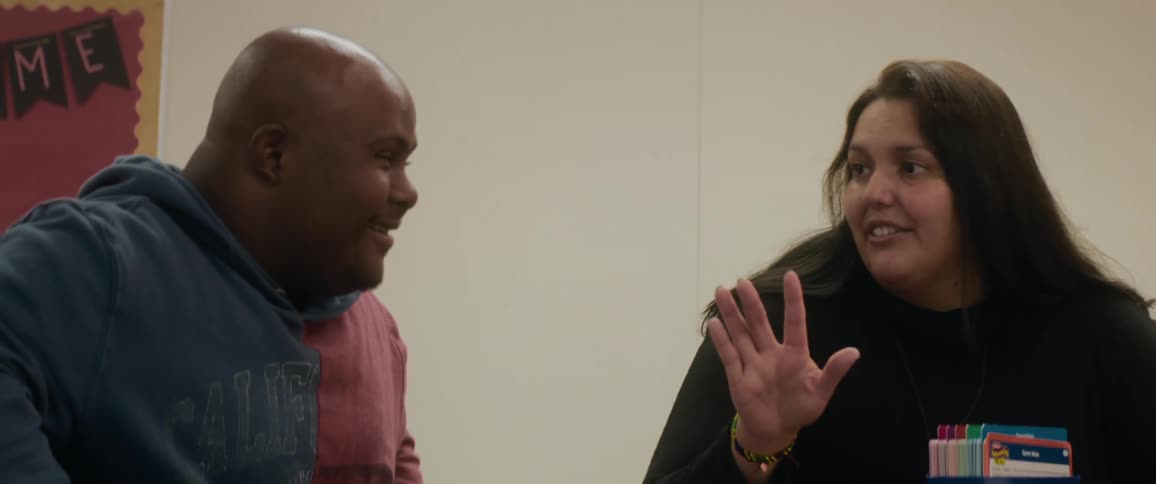 Two people sitting in an indoor room having a conversation