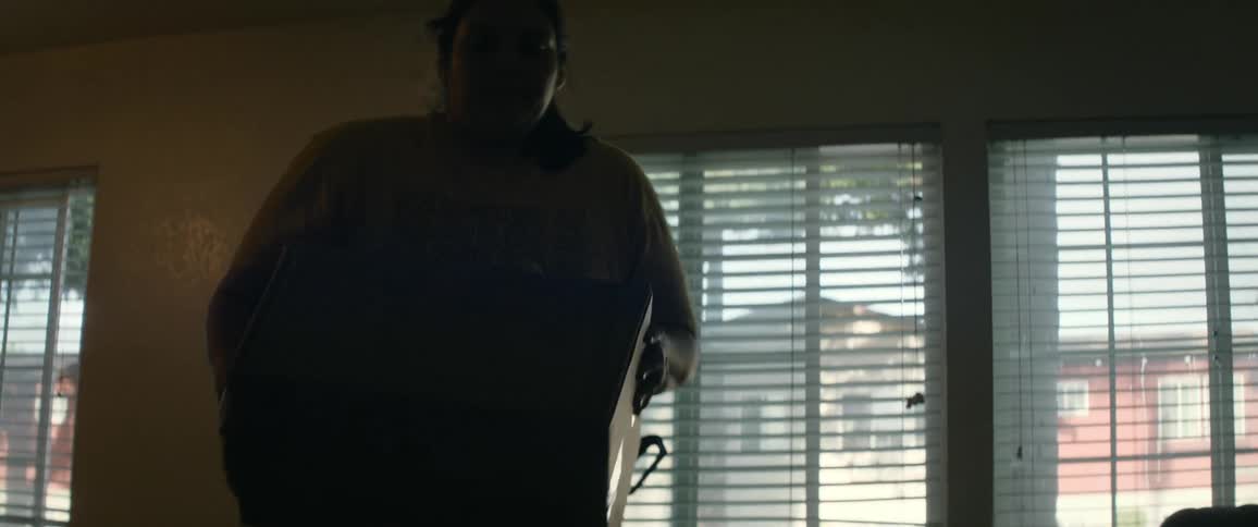 Woman picking up a box and placing it in another location in an indoor room inside a house
