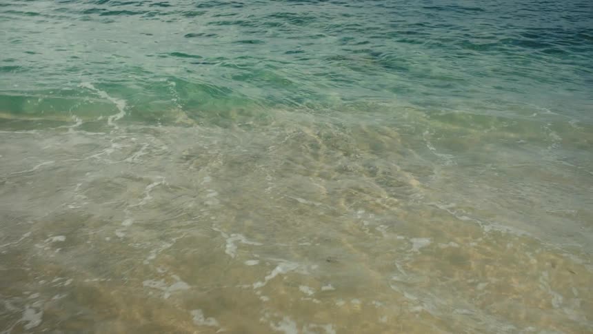 Closeup of the seaside with calm and crystalclear waves
