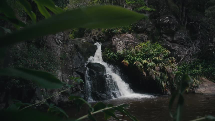 Water from a stream that falls on rocks and ends up in a small lake