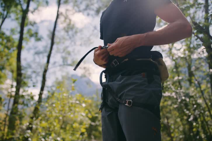 A rock climber gets his gear ready
