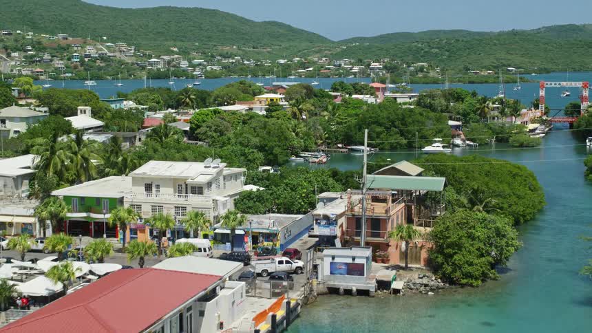 Aerial of a tropical island paradise with yachts anchored in the marina